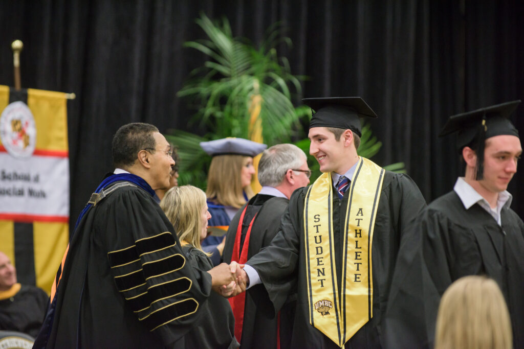 Pres. Hrabowski shakes students hands during winter 2016 undergraduate commencement