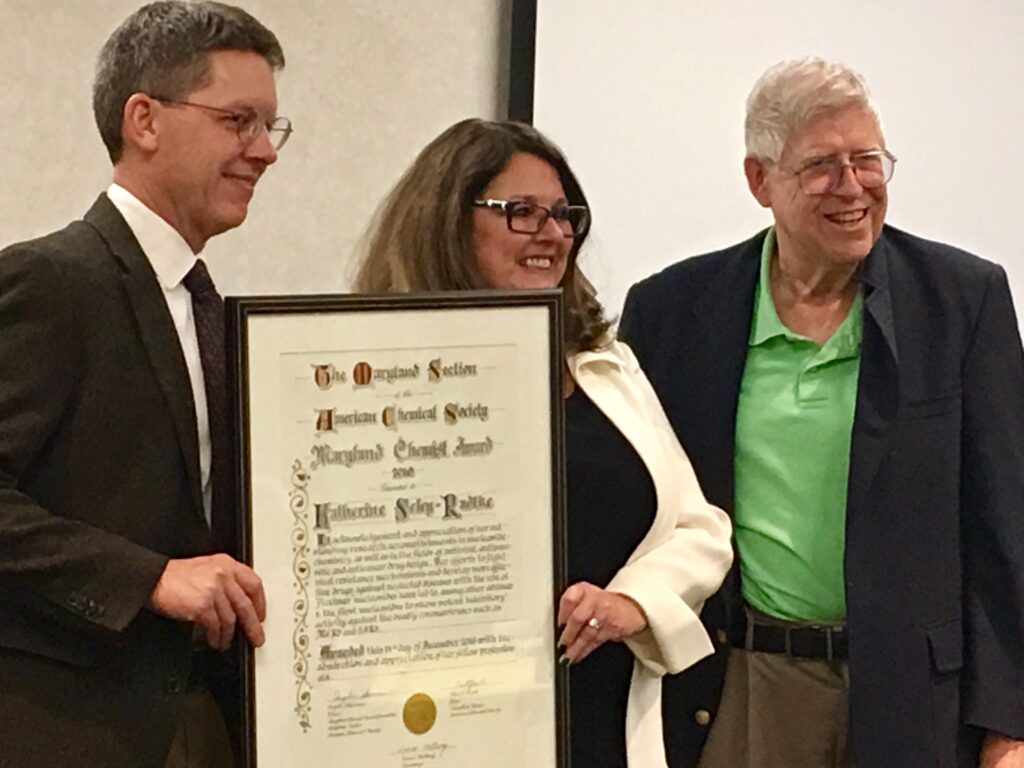 Katherine Seley-Radtke is recognized as Maryland Chemist of the Year. Previous UMBC recipients Michael Summers (left) and Joel Liebman show their support.
