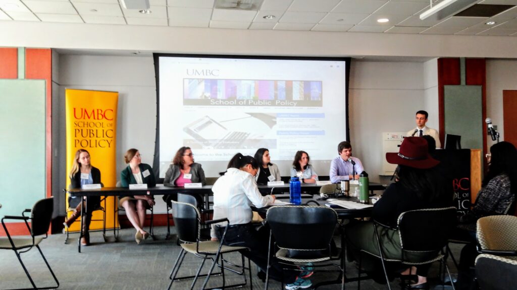 Chris Curran (right), assistant professor of public policy, introduces the panel.