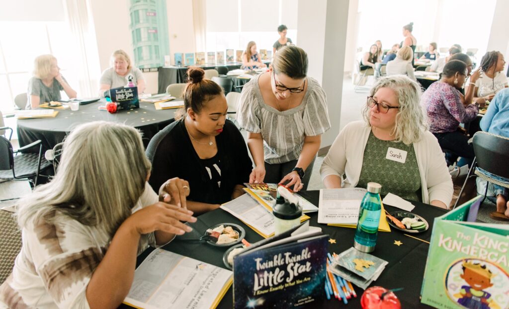 Featured image: Jennifer Mata-McMahon (third from left), associate professor of early childhood education, working with Baltimore City teachers at the Sherman Center for Early Learning in Urban Communities' summer institute. 