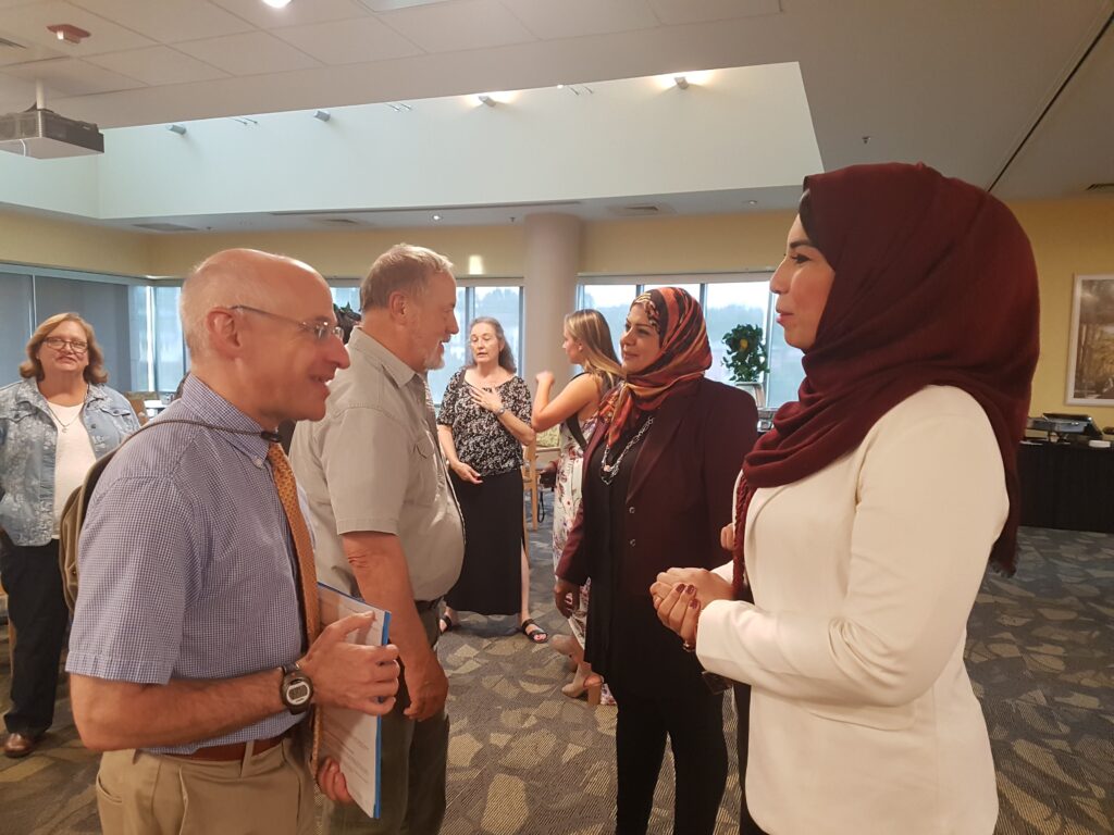 Scot Casper, dean of the College of Arts, Humanities, and Social Sciences, speaking with a faculty from Egypt.